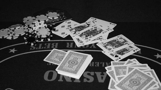 Playing cards and chips spread across a casino poker table