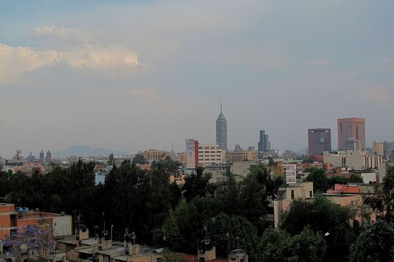 The skyline of Mexico City seen across the rooftops